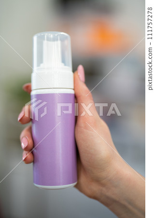 cosmetologist holding a can with a cosmetic product for the skin 111757278