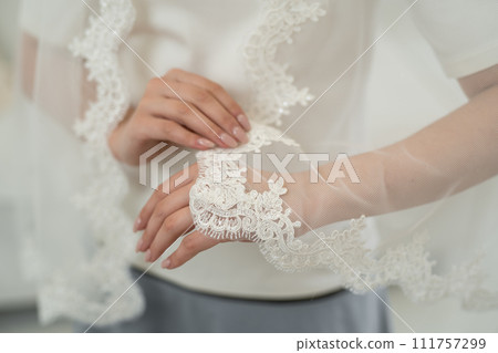 wedding veil close-up of embroidered pattern on hand wedding veil close-up of embroidered pattern on hand 111757299