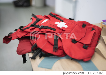 several red body armor for medics on the table several red body armor for medics on the table 111757465
