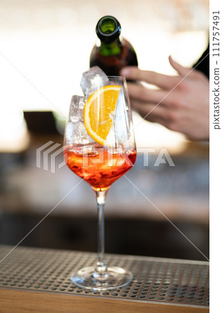 the bartender prepares a beautiful alcoholic cocktail at the bar counter 111757491