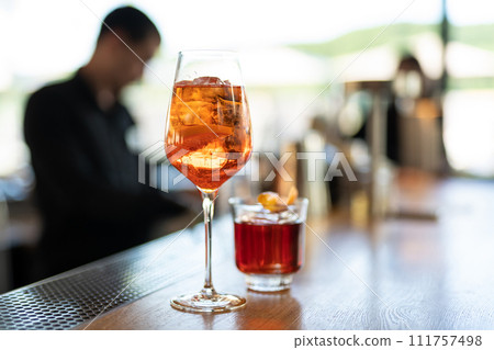 the bartender prepares a beautiful alcoholic cocktail at the bar counter 111757498