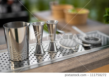 professional accessories on the table for making an alcoholic cocktail by a bartender 111758272