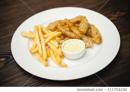menu with fried shrimp and french fries with sauce on a plate. menu with fried shrimp and french fries with sauce on a plate. 111758298