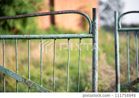 old rusty metal gate with cracked paint 111758848