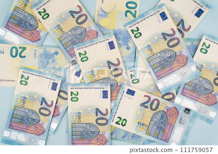 many 20 euro bills on a blue background 111759057