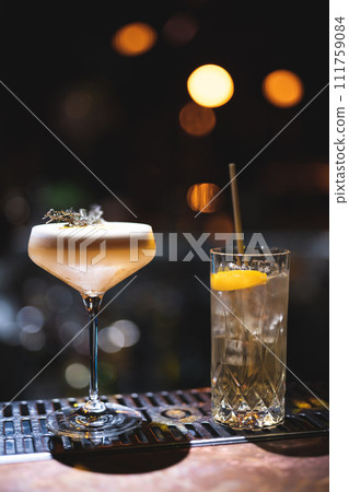 the bartender prepares a beautiful alcoholic cocktail at the bar counter 111759084