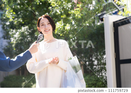 Housewife woman being interviewed on the street 111759729