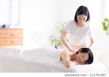 Middle-aged woman and esthetician receiving a massage Middle-aged woman and esthetician receiving a massage 111761867