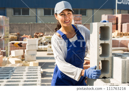 Taskmaster working in outdoor construction material storage 111763216