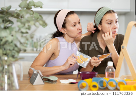 Adult and young women use eye patches 111763326