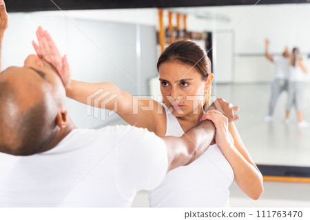 Active woman with professional trainer are training captures on the self-defense course in gym 111763470