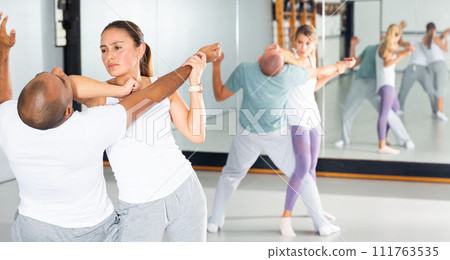Woman and her trainer are training captures on the self-defense course Woman and her trainer are training captures on the self-defense course 111763535