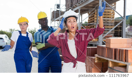 Taskmaster amazed by something in outdoor warehouse 111763967