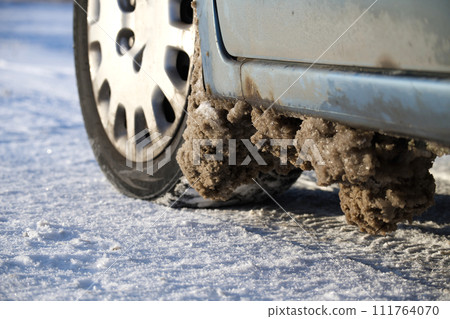 Frozen slush on the bottom of the car Frozen slush on the bottom of the car 111764070