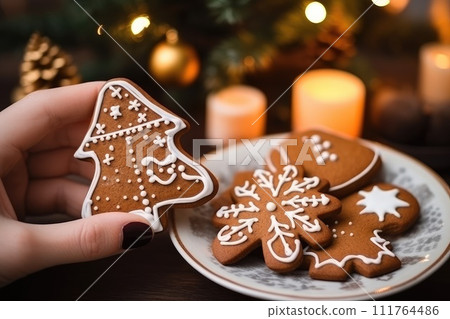 Woman hold A gingerbread man with hot chocolate on the Christmas decorations background. Generative AI 111764486