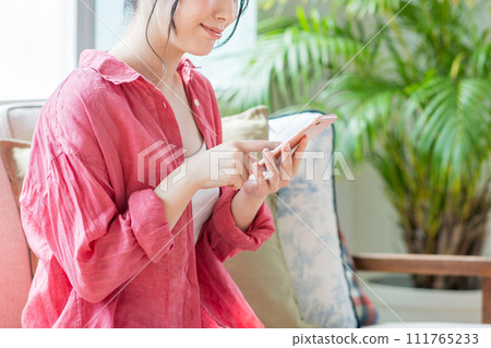 A young woman operating a smartphone. (parts) A young woman operating a smartphone. (parts) 111765233