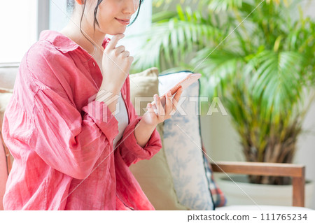 A young woman operating a smartphone. (parts) A young woman operating a smartphone. (parts) 111765234