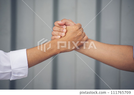 Close up warehouse worker shakehand together. Engineer man hands partnership. Diversity Coworker Men logistics Warehouse teams handshake. Multiracial Support team greeting person teamwork colleagues 111765709