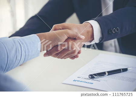 Team Business Partners shaking hands together to Greeting Start up new project. Shakehand Teamwork Partnership at office desk. Businessman partners handshake together.  Business concept 111765725