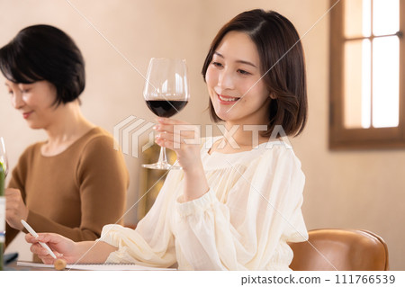 A woman tasting at a wine class A woman tasting at a wine class 111766539