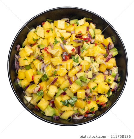 Freshly made mango salsa in a black ceramic bowl Freshly made mango salsa in a black ceramic bowl 111768126