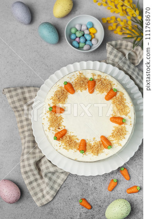 Homemade Easter carrot cake made with walnuts, iced with cream cheese. Sweet dessert. 111768670