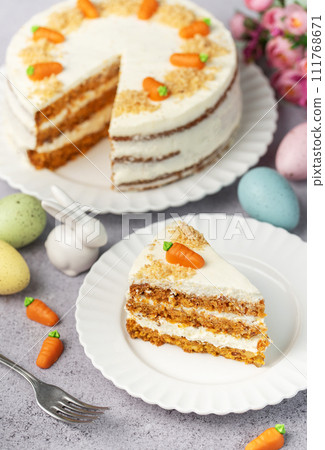 Homemade Easter carrot cake made with walnuts, iced with cream cheese. Sweet dessert. 111768671