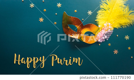 Happy Purim carnival decoration concept made from golden mask star and glitter on dark background. (Happy Purim in Hebrew, jewish holiday celebrate) 111770190