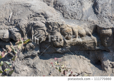 The mystery face carved into rock at entrance of Bentar Candi and Batok volcano in Bromo Tengger Semeru National Park, East Java, Indonesia. 111770860