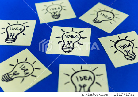 Light bulbs drawn on sticky notes. Hand drawn doodle lineart. Idea, inspiration and creative thinking Light bulbs drawn on sticky notes. Hand drawn doodle lineart. Idea, inspiration and creative thinking 111771752