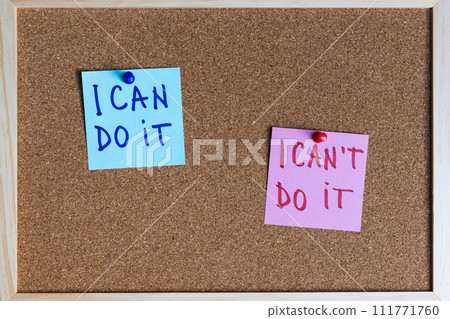 I can do it and I can't do it phrases written on sticky notes pinned at cork board I can do it and I can't do it phrases written on sticky notes pinned at cork board 111771760