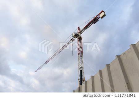 Construction crane with cloudy sky background 111771841