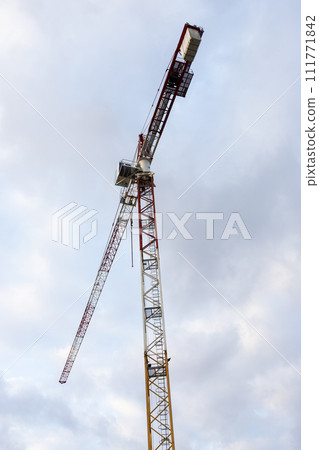 Construction crane with cloudy sky background 111771842