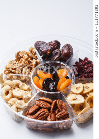 Dried fruits and nuts on a plate to celebrate the Jewish holiday Tu Bi Shvat. 111771892