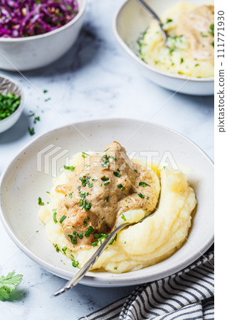 Chicken breast in creamy sauce with mashed potatoes. Chicken breast in creamy sauce with mashed potatoes. 111771930