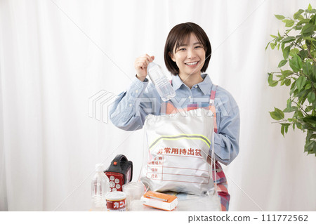 A woman checking the contents of an emergency bag 111772562