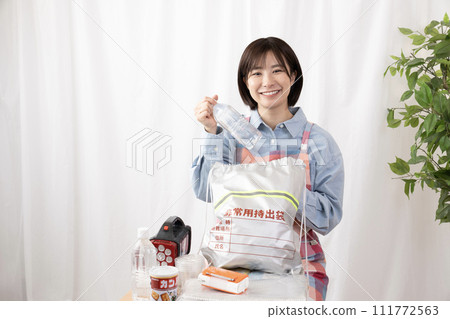 A woman checking the contents of an emergency bag 111772563