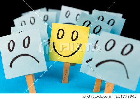Sticky notes with hand drawn Smiley face and Sad faces. Positive way of thinking concept. Positive overcomes negative 111772902