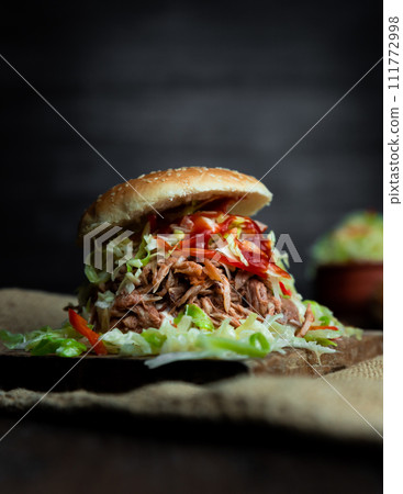 Pulled pork sandwich with coleslaw, buns and seasoning. Pulled pork burgers Pulled pork sandwich with coleslaw, buns and seasoning. Pulled pork burgers 111772998
