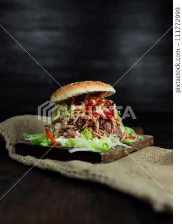 Pulled pork sandwich with coleslaw, buns and seasoning. Pulled pork burgers Pulled pork sandwich with coleslaw, buns and seasoning. Pulled pork burgers 111772999