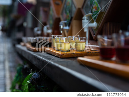 Assortment of hard strong alcoholic drinks and spirits in glasses on bar counter 111773034