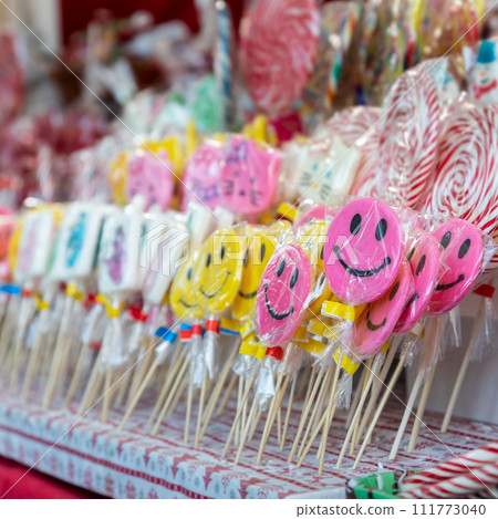 Candy lollipops with smiling emoticon on the christmas stand Candy lollipops with smiling emoticon on the christmas stand 111773040