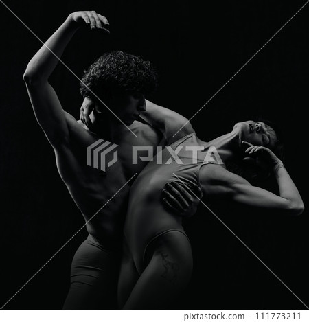 Portrait of passion and love. Talented, artistic young man and woman, ballet dancers making performance. Black and white 111773211