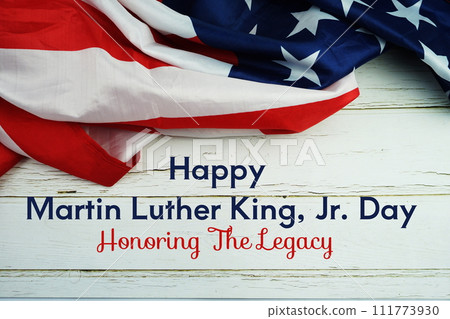 Happy Martin Luther King Jr Day text messege with USA flag on wooden background Happy Martin Luther King Jr Day text messege with USA flag on wooden background 111773930