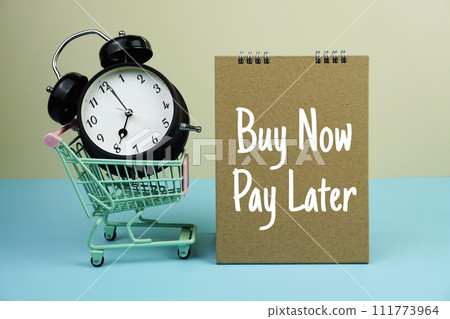 Buy Now Pay Later text message with trolley cart and alarm clock for business and commercial concepts background Buy Now Pay Later text message with trolley cart and alarm clock for business and commercial concepts background 111773964