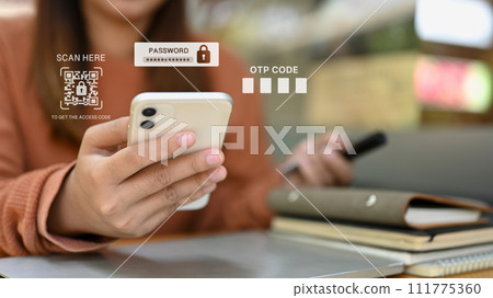 Hands entering verification code on smartphone for login to web page. Authentication and security concept Hands entering verification code on smartphone for login to web page. Authentication and security concept 111775360