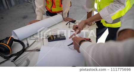 Construction concept of Engineer or architect meeting for project working with partner and engineering tools on building and blueprint in working site Construction concept of Engineer or architect meeting for project working with partner and engineering tools on building and blueprint in working site 111775696