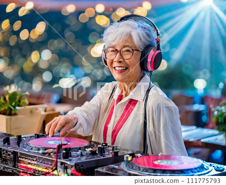 A cheerful old woman playing DJ 111775793