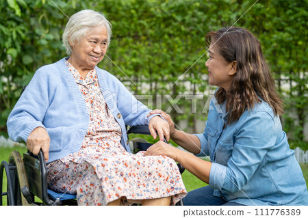 Caregiver help and care Asian senior woman patient sitting on wheelchair at nursing hospital ward, healthy strong medical. 111776389