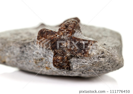 macro mineral stone Staurolite on a white background macro mineral stone Staurolite on a white background 111776450